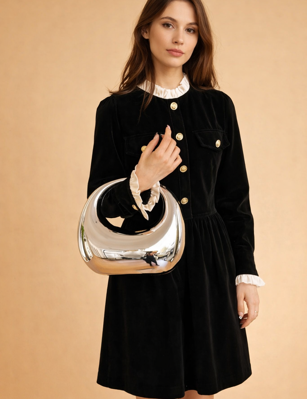 european-fashion-model-holding-silver-crescent-handbag-studio-pose.png