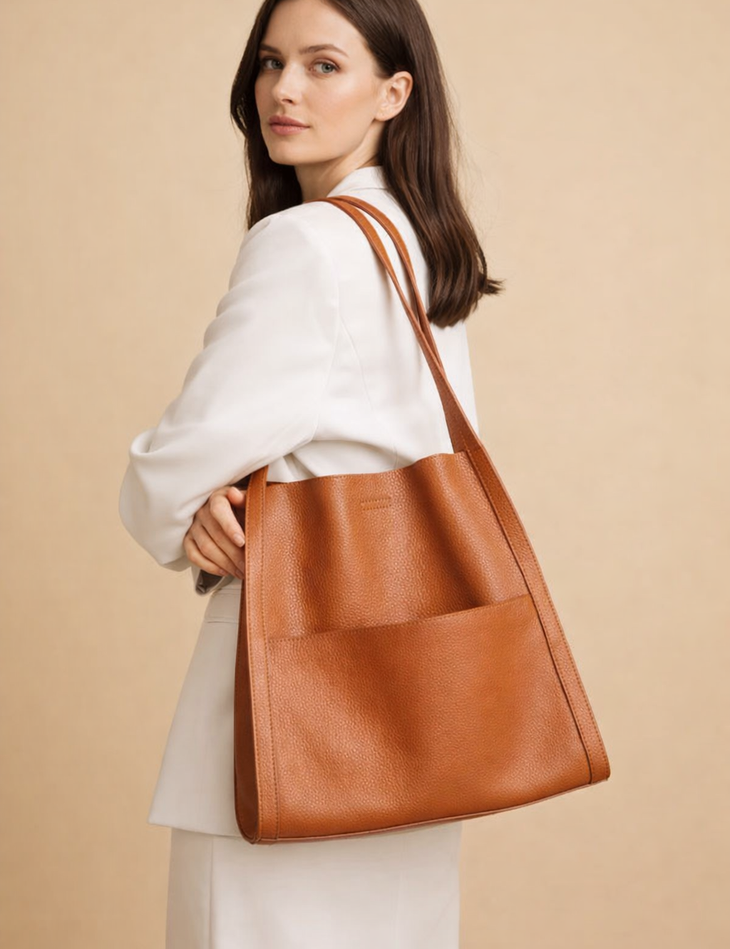 european-female-model-carrying-cognac-leather-tote-bag-studio-pose.png
