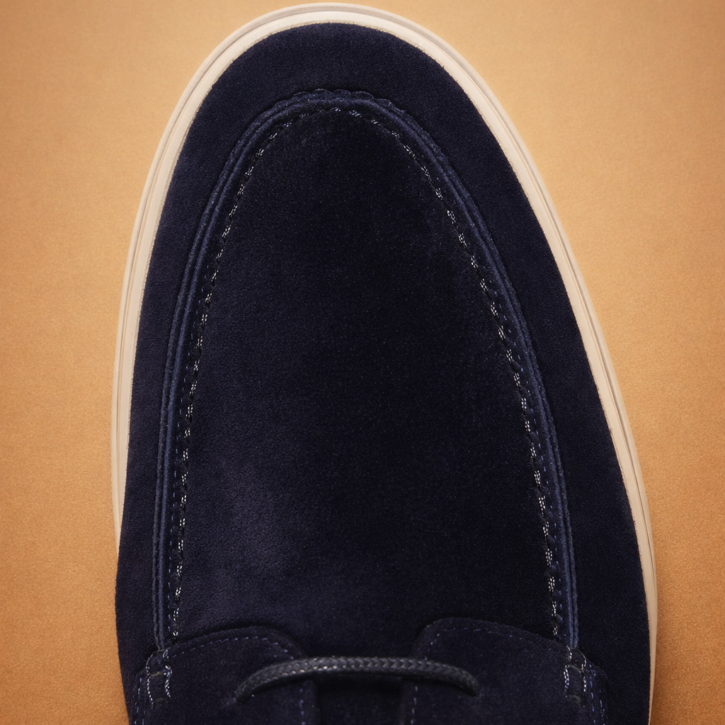 european-luxury-menswear-model-posing-navy-suede-shoes-white-tailored-trousers-studi.png
