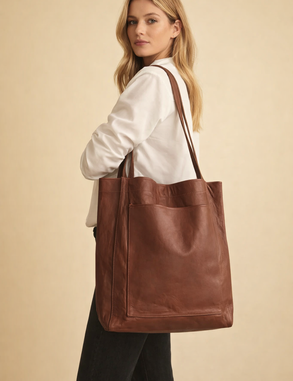 european-polish-female-model-wearing-brown-leather-tote-bag-studio-fashion-pose.png