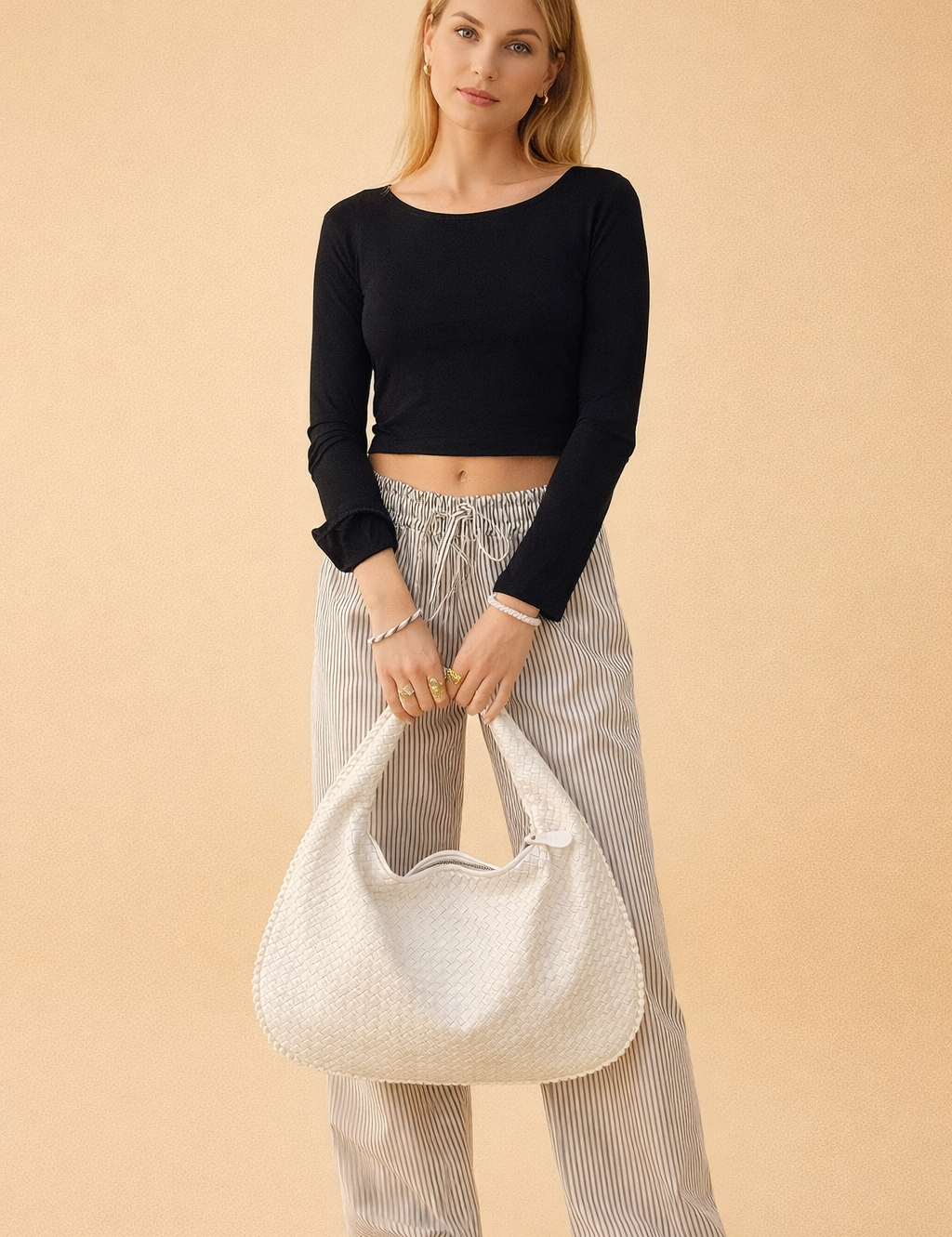 polish-fashion-model-holding-white-woven-hobo-bag-european-studio-pose.png