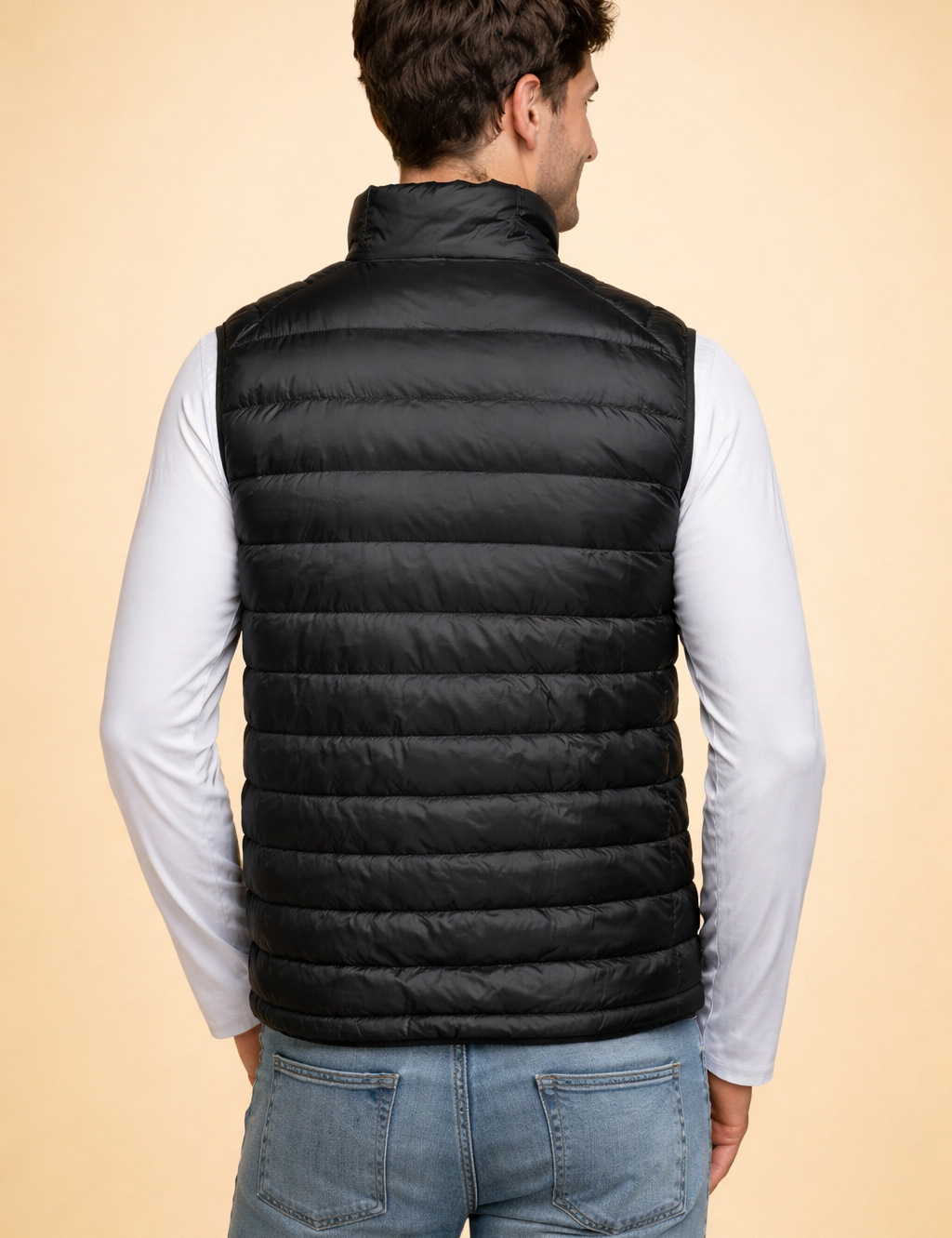 polish-male-model-back-view-black-quilted-puffer-vest-studio-shot-warm-sand-background.png