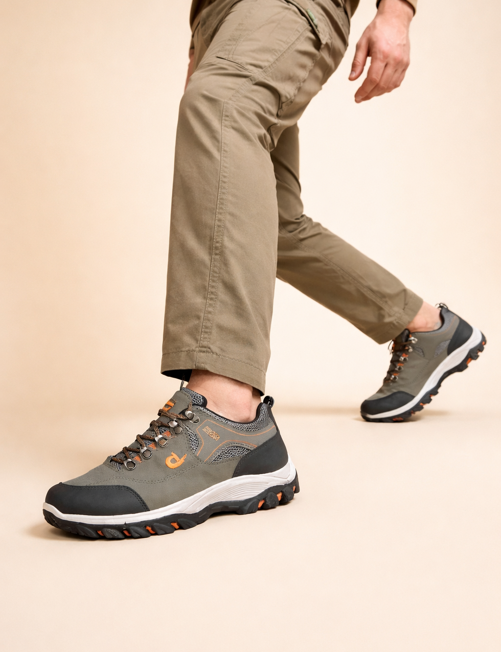polish-male-model-wearing-grey-orange-hiking-shoes-european-studio-step-forward-pose.png